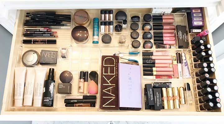 view from above of makeup palettes organized in drawer